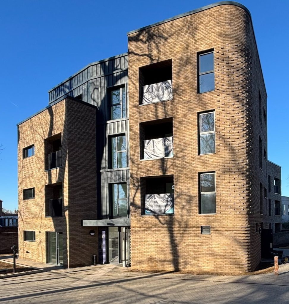 Front view of an apartment block in sunshine