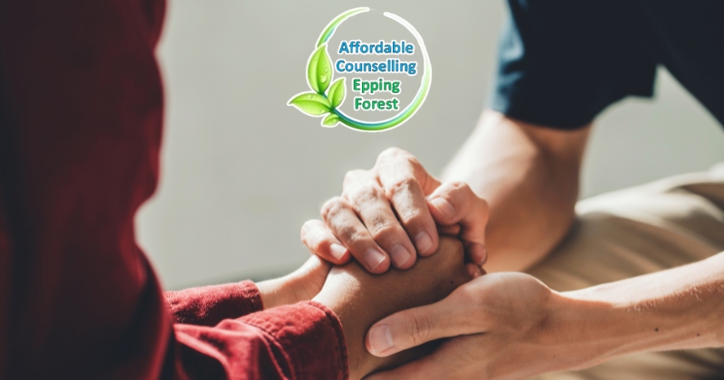 a person consolling another person, holding hands