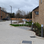 New road layout with landscaping and bike racks at Milbourne Close