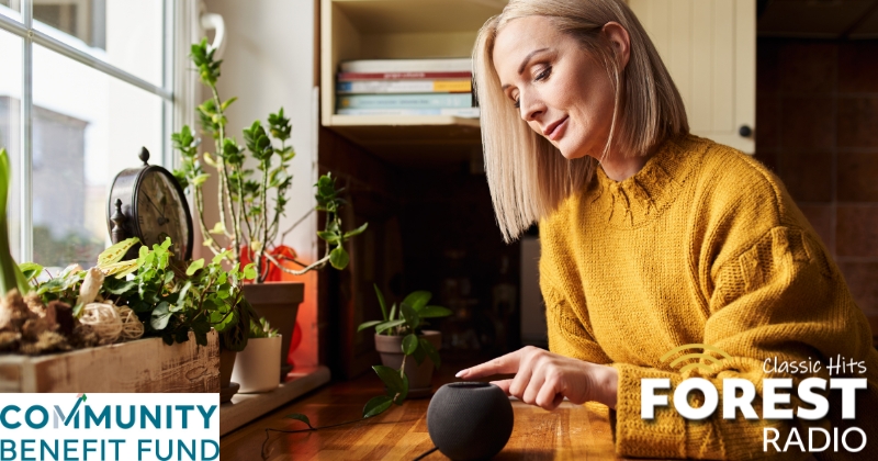 a woman listening to the radio in her kitchen