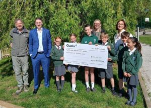 Pictured (left to right) Mr Rall, headteacher, Ben Johnson, Dawn Harrison, EFDC Service Director Housing and Property and Julia Legood, Qualis Senior Business Support Coordinator, with some of the pupils.