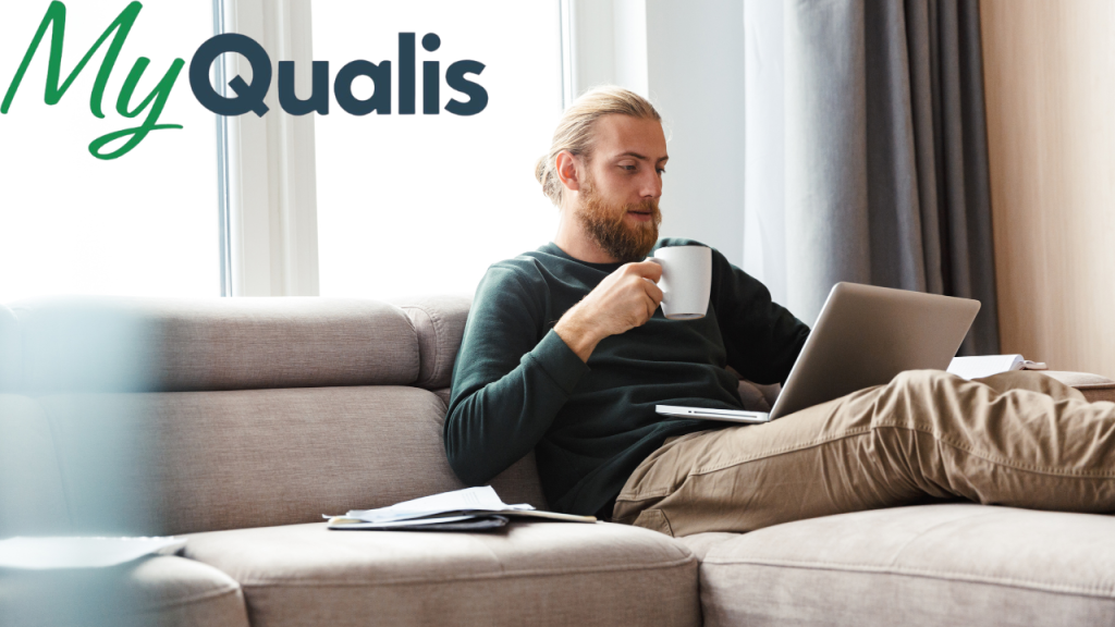 young bearded man sitting in home using laptop