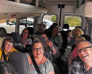 a group of adults in a mini van